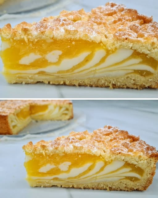 Tarta de naranja con capas de crema de naranja y crema de leche, decorada con un toque crujiente en la parte superior.