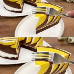Pastel cremoso de cacao y cúrcuma, con capas de cobertura cremosa en tonos dorados, servido en un plato.
